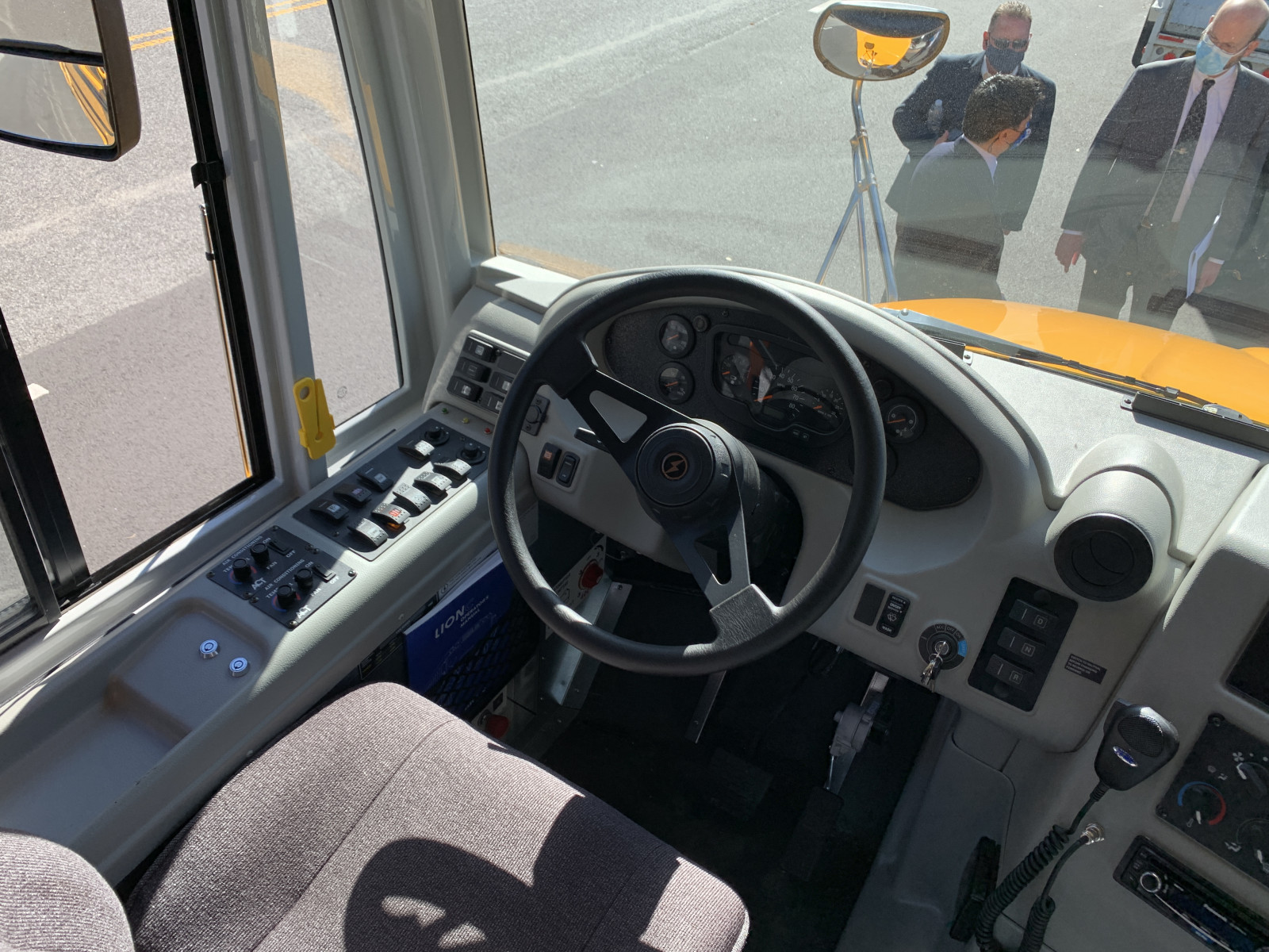 The gray front seat of a yellow school bus.
